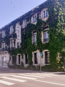 un bâtiment avec du lierre sur son côté dans l'établissement Le Château, à Tournon-sur-Rhône