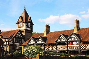 a large building with a clock tower and a building at Tilly's a perfect apartment in the Market Town of Ledbury in Ledbury
