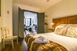 una camera da letto con un letto grande e una sedia di Parking - Le Wild Forest - Centre Historique a Phalsbourg