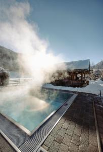 a hot tub with steam coming out of it at BERGZEIT by seven in Flachau