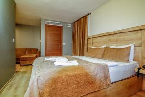 a bedroom with a large bed with a wooden headboard at Double DD Hotel in Istanbul