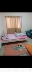 a bedroom with a bed with a window and a rug at Transient furnished. Room just 1 min to Al ain mall in Al 'Ayn