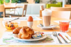 a plate of pastries and an egg on a table at Hotel A1 Grauholz in Bern