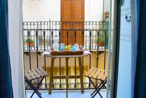 stół na balkonie z 2 krzesłami w obiekcie Porto Salvo Apartments - by Vacation Service w Cefalù