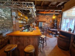 a bar in a restaurant with wooden tables and chairs at Brb in Laniscat