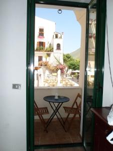 a room with a table and a view of a building at Casa Cardi in Sperlonga