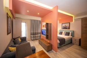 a bedroom with a bed and a couch and a tv at Istanbul Taksim MARİDA SUIT in Istanbul