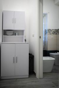 a bathroom with white cabinets and a tub and a toilet at L’Archè Lodovico il Moro – House on the Navigli River in Milan +29 photos