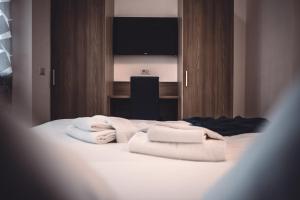 a bedroom with white towels on a bed at L’Archè Lodovico il Moro – House on the Navigli River in Milan