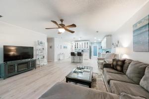 a living room with a couch and a flat screen tv at 1217 Lagoon Villas in Fernandina Beach