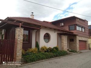 a house with a brown and white at Besenyei Apartman in Sárvár