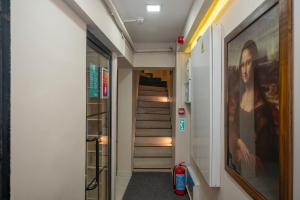 a hallway with stairs and a painting of a woman at Istanbul Taksim MARİDA SUIT in Istanbul