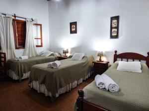 A bed or beds in a room at Hostal Mirador del Valle