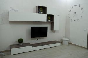 a living room with a flat screen tv on a wall at A due passi dal centro e dal mare in Marsala