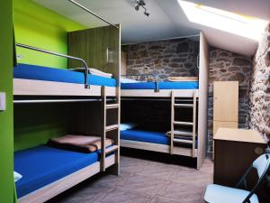 a room with three bunk beds in a room at Albergue O Logoso in Campelo