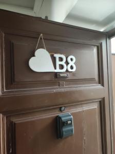 a wooden door with a heart sign on it at La maison b8 in Rome