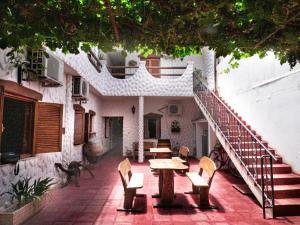 a patio with a table and chairs and stairs at Hostal Mirador del Valle in Cafayate