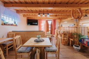 a dining room with wooden tables and chairs at Penzión Natália in Terchová