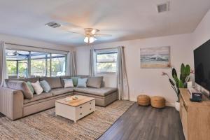 a living room with a couch and a tv at Sarasota Serenity in Sarasota