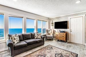 a living room with a couch and a flat screen tv at Cape Kuh'lye in Lincoln City +40 photos