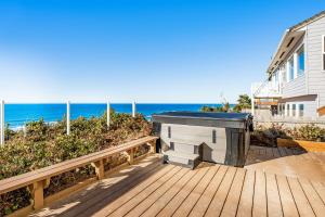 a wooden deck with a jacuzzi on the beach at Cape Kuh'lye in Lincoln City