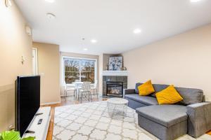 a living room with a couch and a fireplace at City Sojourn in Seattle