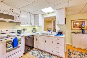 a kitchen with white cabinets and a sink at Haddock Haven-3 in Lake Junaluska