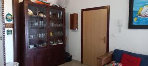 a living room with a wooden cabinet and a door at Esprit caraïbes in Le Diamant
