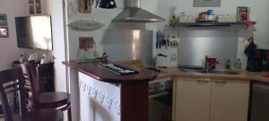 a small kitchen with a counter and a sink at Esprit caraïbes in Le Diamant +14 photos