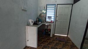 a small kitchen with a sink and a refrigerator at HOME2STAY CHE MAIL 1 KUALA ROMPIN in Kuala Rompin