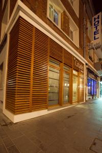 a store front with wooden doors on a street at Citadel Hôtel in Calais