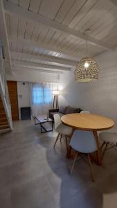 a living room with a table and a couch at ONE Departamentos in Tandil