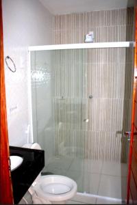 a bathroom with a shower with a toilet and a sink at Viana Praia Hotel e Restaurante- Pontal do Peba-Piaçabucu in Piaçabuçu