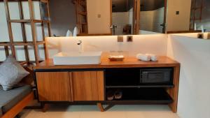 a bathroom with a counter with a sink and a microwave at HALO Sustainable Resort Karimunjawa in Karimunjawa +21 photos