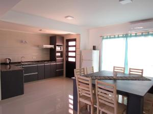 a kitchen and dining room with a table and chairs at Duplex Villanueva in San Rafael