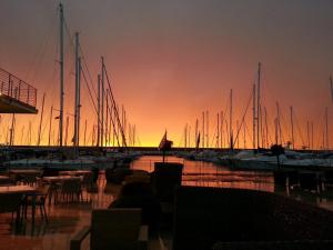 a view of a marina at sunset with boats at Piccolo Hotel in Rosignano Solvay