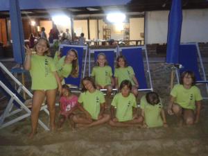 a group of girls in green shirts posing for a picture at Piccolo Hotel in Rosignano Solvay