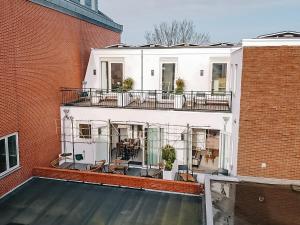 a building with a swimming pool next to a brick building at Boutique hotel Margretha in Zandvoort