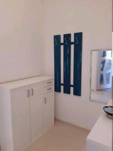 a room with white cabinets and a mirror at Perfect apartment to visit the fair or city in Düsseldorf