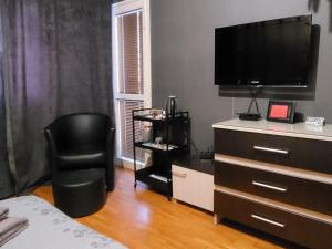 1 dormitorio con tocador, TV y silla en New York - guest room near the Airport, transport possibility en Sofía