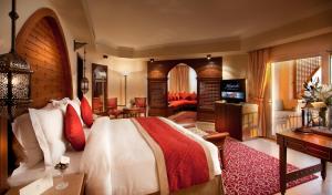 a bedroom with a bed and a living room at Kempinski Hotel Soma Bay in Hurghada