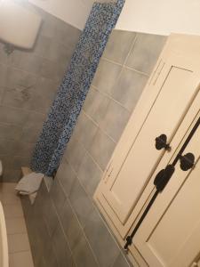 a bathroom with a white door and a shower at Agriturismo Cognanello in Montepulciano +23 photos