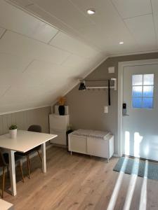 a room with a table and a bench in a attic at Modern, small appartment in Larvik