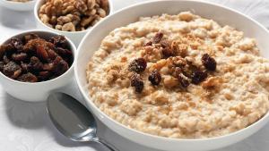 a bowl of oatmeal with raisins and other nuts at Arkadia Hotel in Saint Petersburg