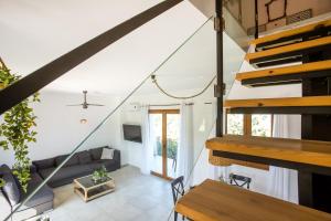 an open living room with stairs and a couch at Villa Kora in Kallithea Rhodes