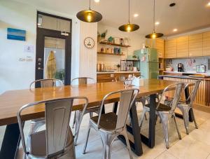 a kitchen with a large wooden table and chairs at 水蛙春 in Hengchun South Gate