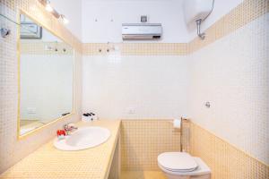 a bathroom with a sink and a toilet at Orange Villasimius House in Villasimius