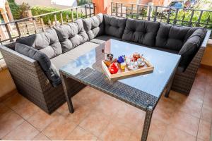 a couch and a table with figurines on it at Orange Villasimius House in Villasimius +9 photos