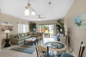 a living room with a couch and a glass table at Gulf Walk 606 in Destin