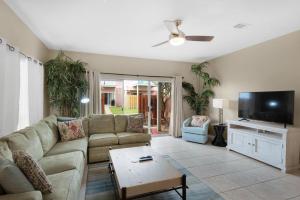 a living room with a couch and a flat screen tv at Gulf Walk 606 in Destin